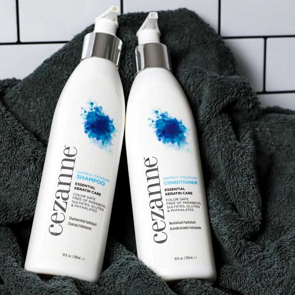 Two bottles of Cezanne shampoo and conditioner on a towel.