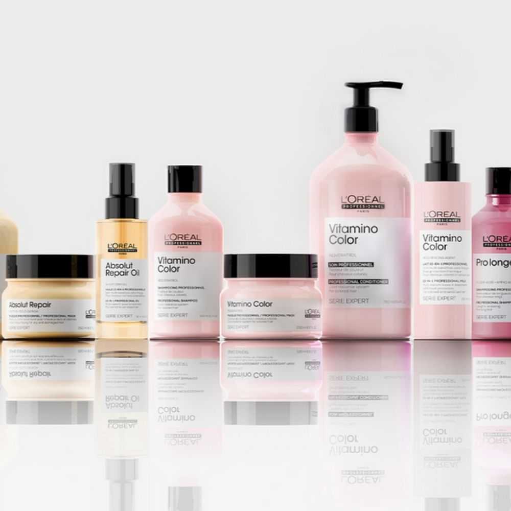 A range of L'Oreal hair care products displayed on a reflective surface.